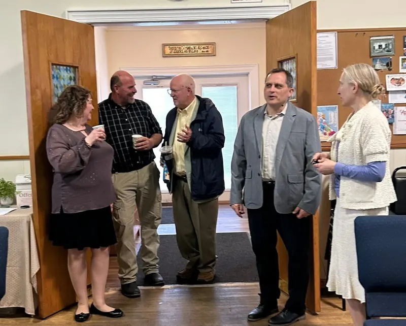 Church members chatting over coffee after Sunday worship at The Well EPC.