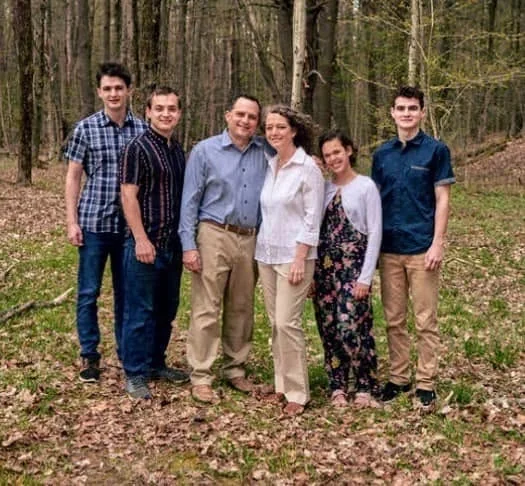 Pastor Adam Hungerford and his wife Tracey, center, with their family.